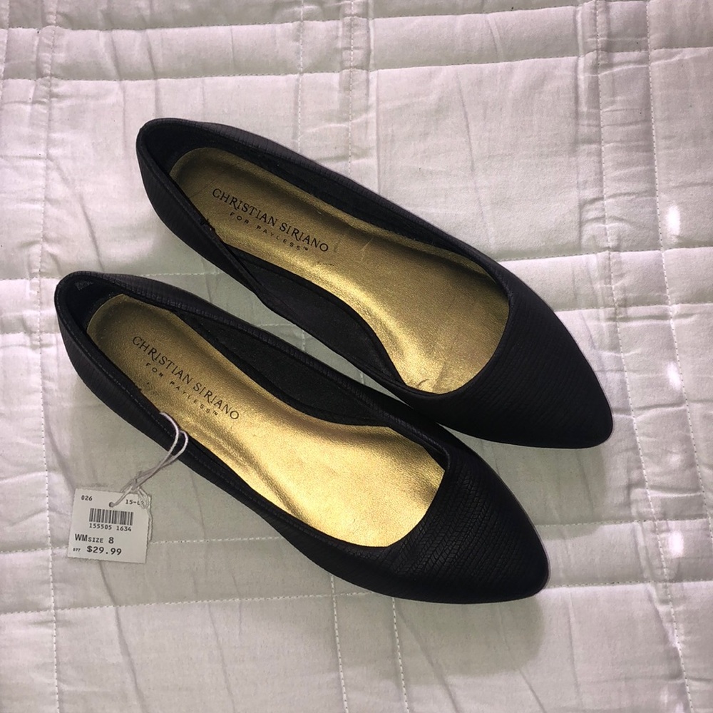 Women’s black flat closed-toe shoes.